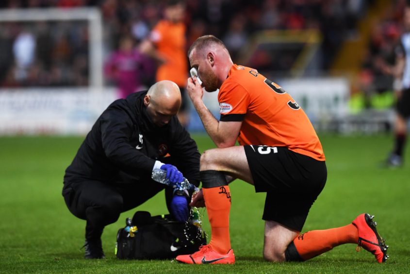Mark Connolly receives treatment for a head knock.