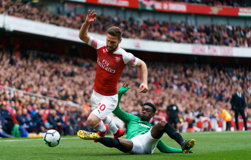 Arsenal's Shkodran Mustafi, (left) is tackled by Brighton and Hove Albion's Yves Bissouma (right) during the Premier League match at the Emirates Stadium, London.