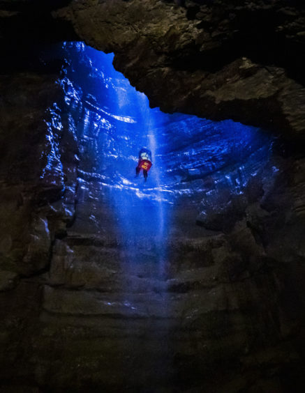 A potholer is winched into Gaping Gill, the largest cavern in Britain, situated in Yorkshire Dales National Park, ahead of its opening the public next weekend.