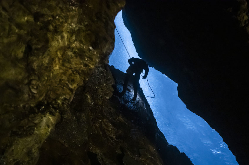A potholer abseils into Gaping Gill, the largest cavern in Britain, situated in Yorkshire Dales National Park, ahead of its opening the public next weekend.