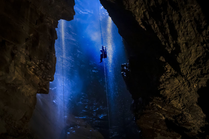 A potholer is winched into Gaping Gill, the largest cavern in Britain, situated in Yorkshire Dales National Park, ahead of its opening the public next weekend.