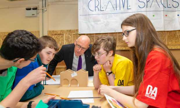 MSP John Swinney speaks to pupils Sven Thomson, Jack Smith, Amy Kelly and Fern Semple from Anderson High School.