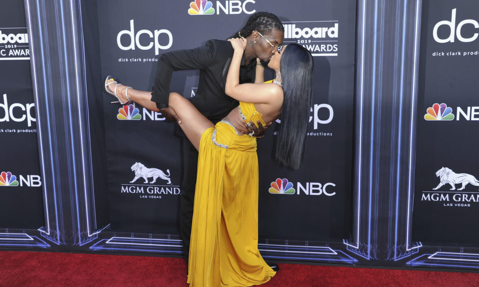 Offset, left, and Cardi B kiss as they arrive at the Billboard Music Awards.