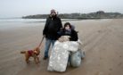 Sarah Lux using one of St Andrews beach wheelchairs with her partner Ian Martin and dog ‘Teddy’ on the West Sands.