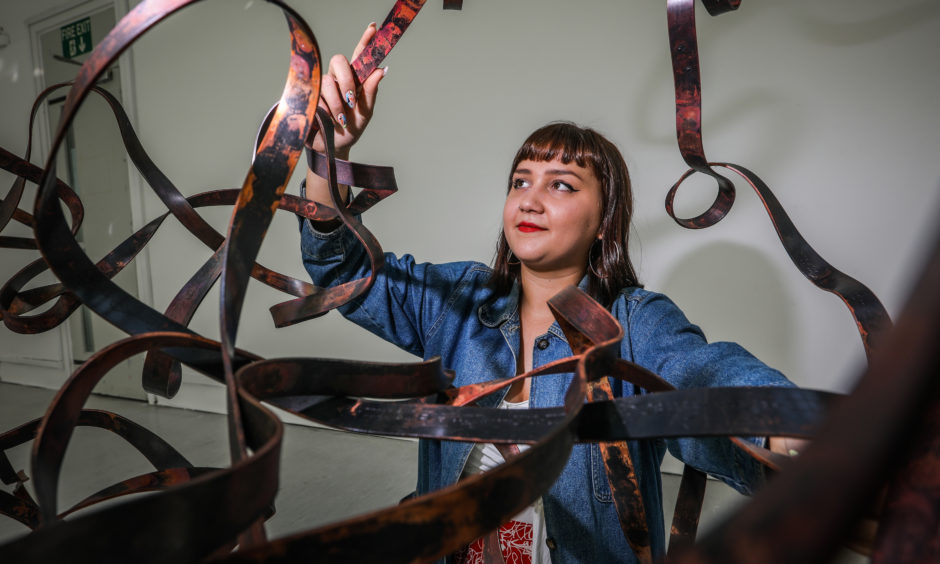 Saskia Singer, 24, a visual artist with one of her pieces.