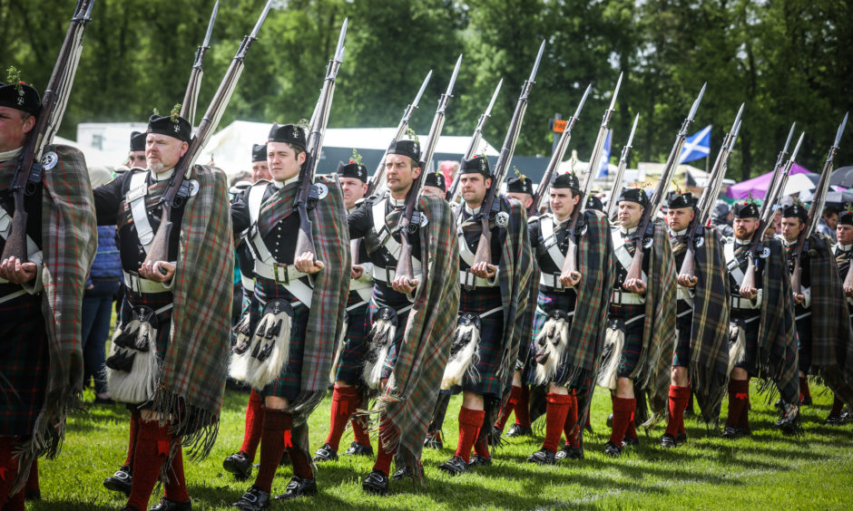 The Atholl Highlanders march into the arena.