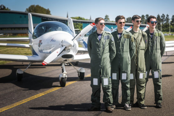 Air Cadets Ross Pratt, Patrick Ahern, Robert Gates and Matthew Forey with one of the planes