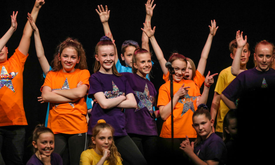 Pupils from Oakbank Primary School perform on stage.