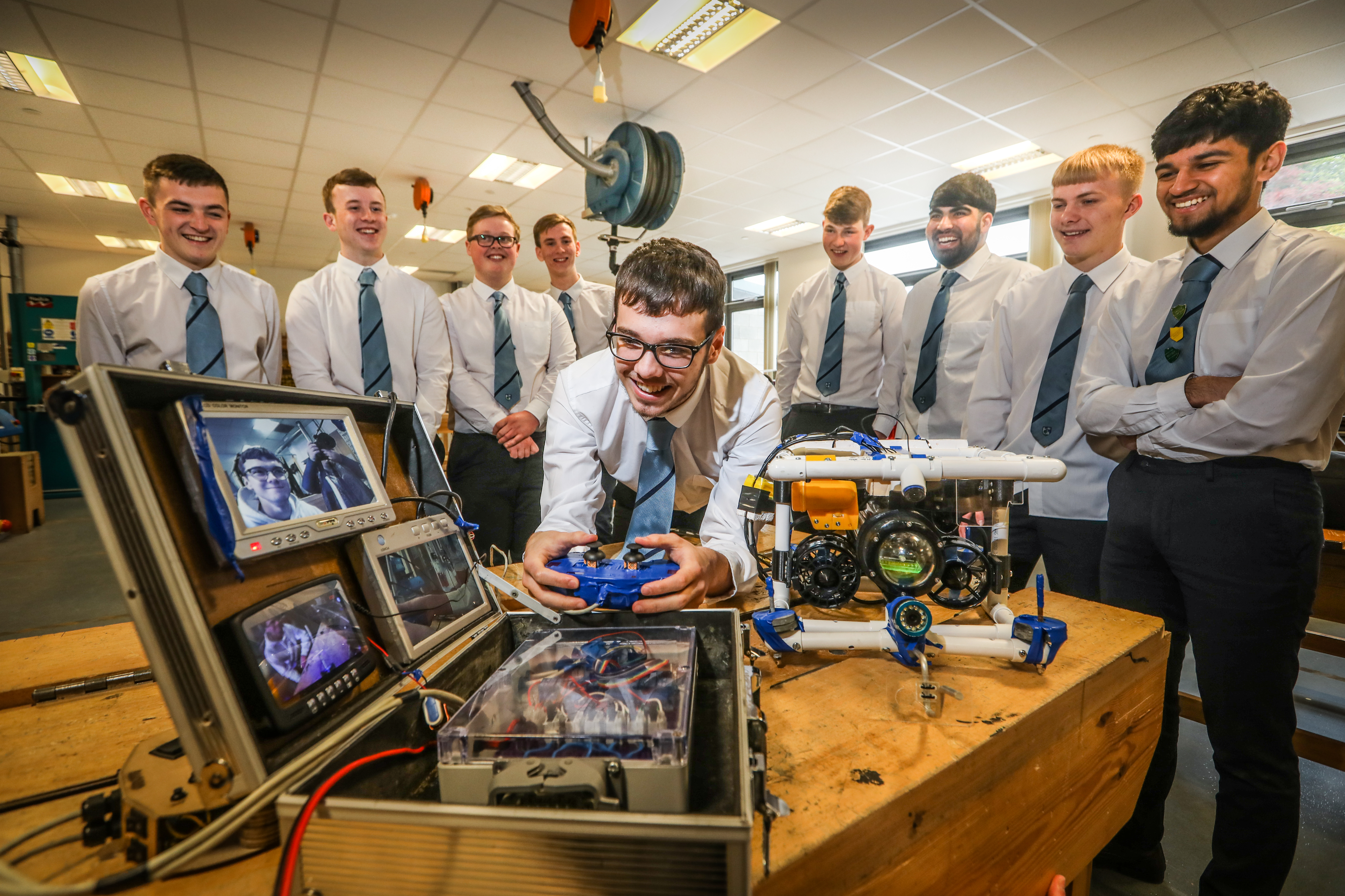 S6 pupil Aidan McIrvine, 17, and other pupils who are taking part in the competition with one of their machines named 'Discovery.'