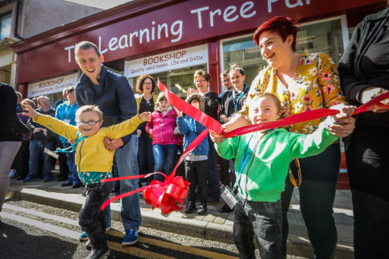 Ollie and Cameron with mum and dad Elaine and Al, opening the new shop.