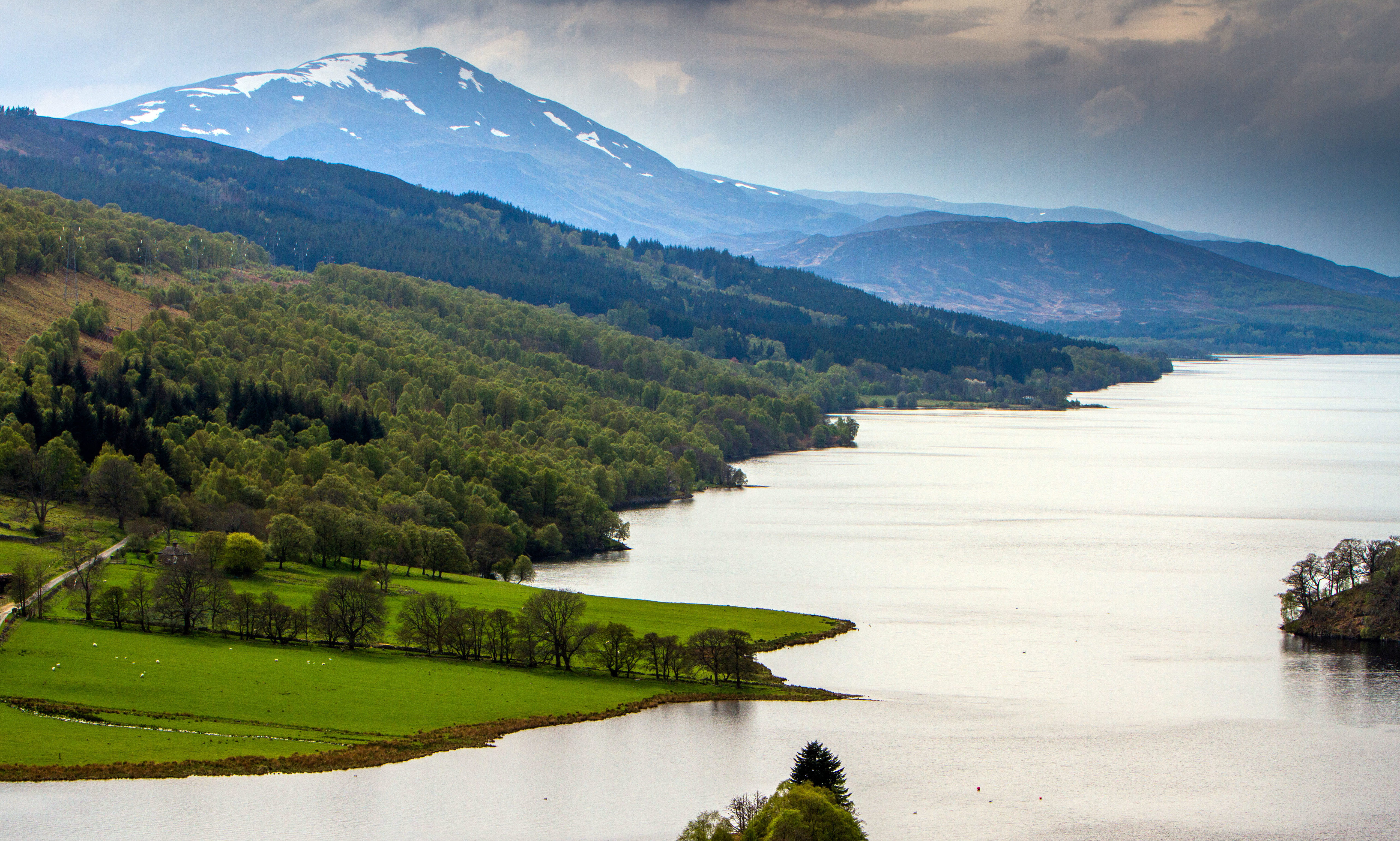 The view of Loch Tummel surrounded by part of the Tay Forest Park and Schiehallion in the background.