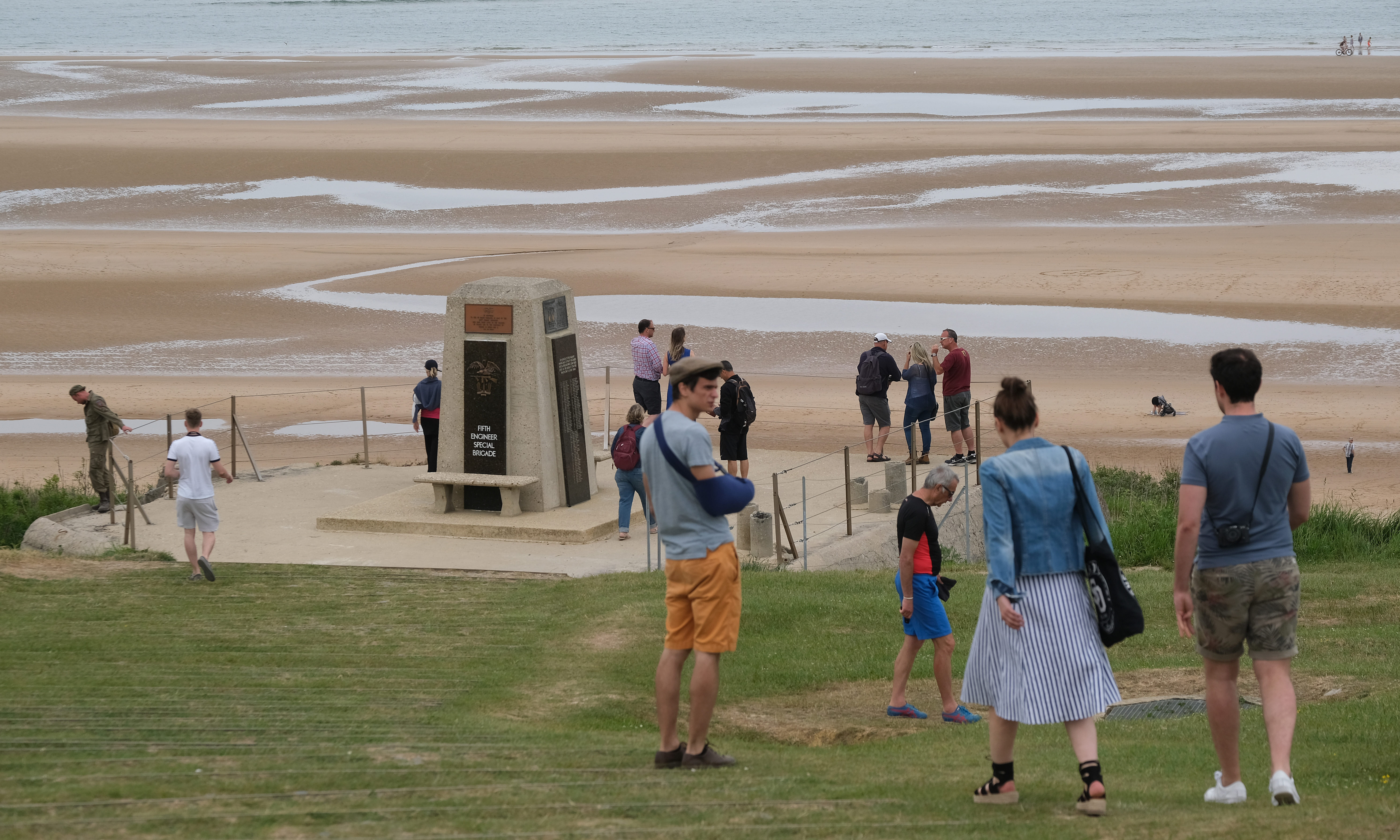 Visitors walk toward a monument to the soldiers of a US unit killed in the D-Day assault at Omaha Beach in Normandy on June 02, 2019 near Colleville-sur-Mer, France.