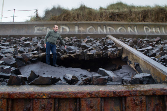 Councillor Bill Duff inspecting the damage at Montrose beach.