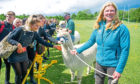 The school pupils meet the alpacas led by Graeme Nicoll and Lou Nicoll (foreground), Monifieth High School.