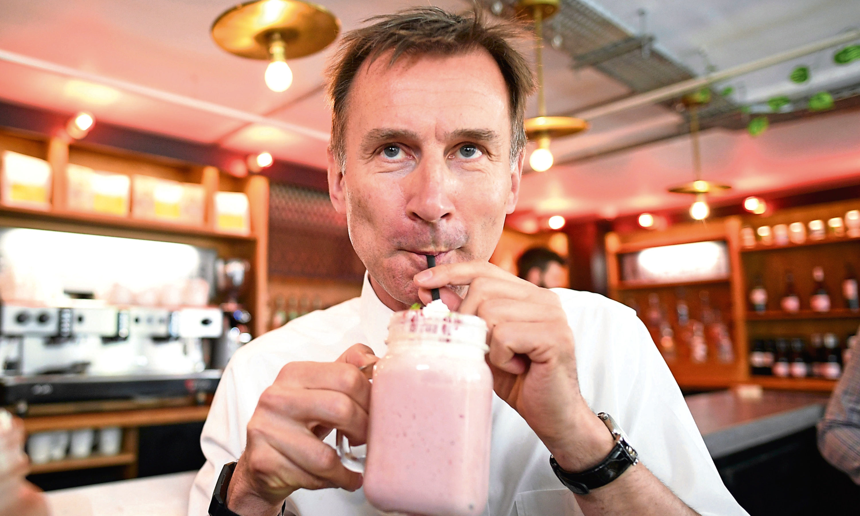Conservative party leadership candidate Jeremy Hunt sips a shake