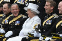 Brigadier Melville Jameson (second left) enjoys a laugh with the Queen during a visit to The Royal Scots Dragoon Guards at Redford Barracks, Edinburgh.