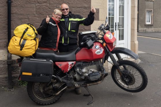 Rudolph and his wife with the recovered motorbike.