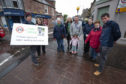 Locals in Coupar Angus promote their 20 MPH speed campaign at the Cross, Organiser Michael Gallagher holding sign
