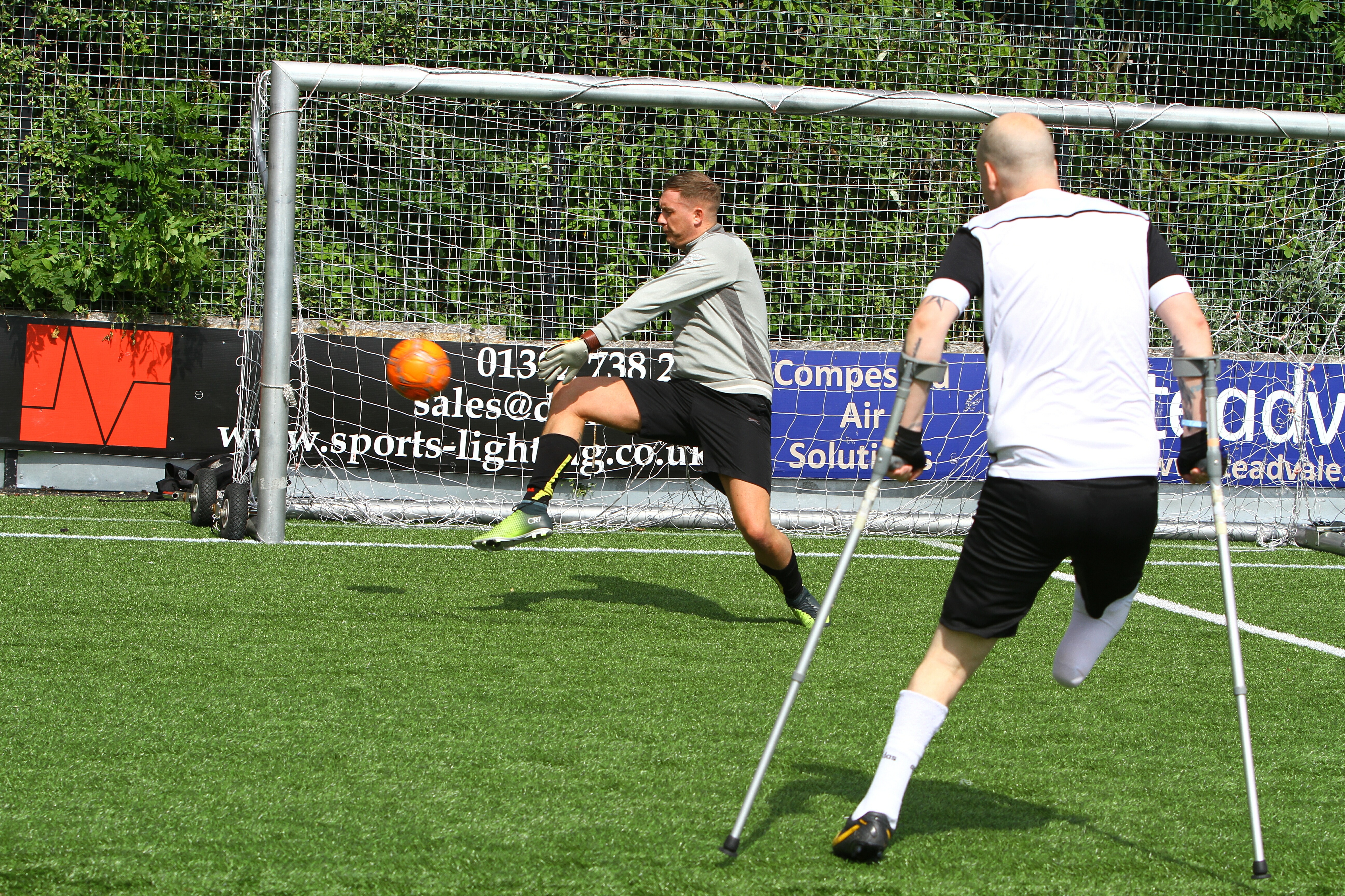 Rob Wilson firing in a shot with Steven Tully in goal, at the Amputee Football Programme training session at the GA Arena in Dundee