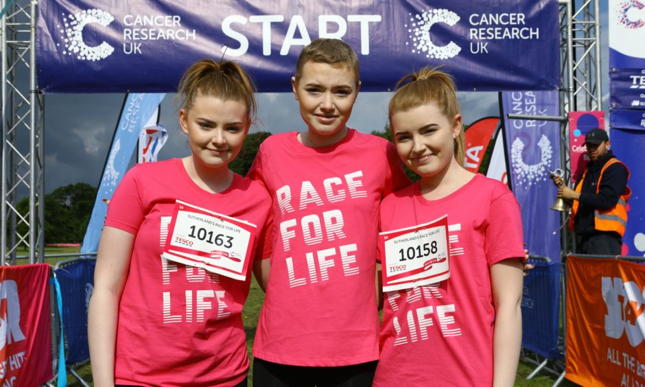 Ellie Sutherland, centre, who rang the bell to start the Race For Life, with her sisters Megan, left, and Danielle, at the Race For Life in Camperdown Park.