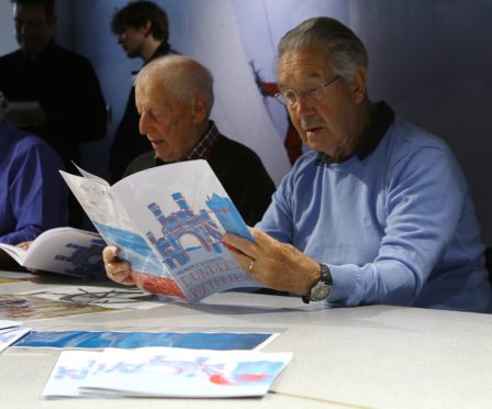 Jim Houston, right, and Ronald Milne look through Memory Exchange Dundee's Waterfront