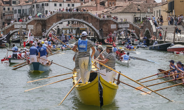 A boat passes through the Cannaregio Canal on June 09, 2019 in Venice, Italy. The 32 km course goes around the lagoon and arrives in the Grand Canal. The event was established in 1974 as a protest against the waves in Venice, caused by the transit of too many motor boats.