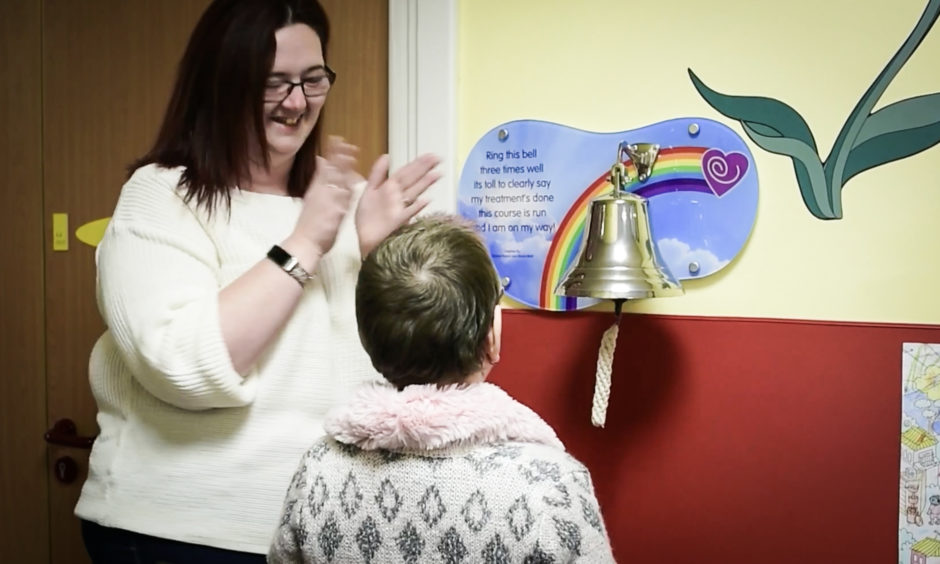 After a year of treatment Holly rings the final treatment bell.