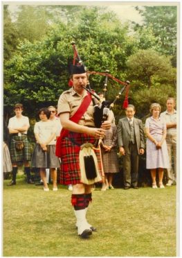 John playing the pipes at an event in Japan in 1975.