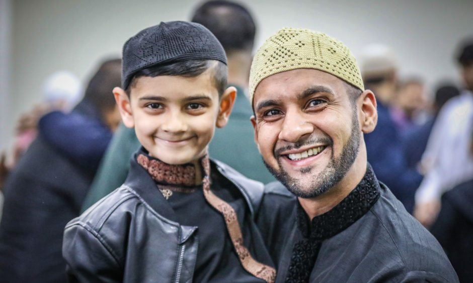 The local Muslim community celebrate Eid at Dundee Islamic Society, to mark the end of Ramadan. Pic shows; a father and son (on his first visit to the Mosque) after prayers and celebrations at Dundee Islamic Society mosque to celebrate Eid. Pic by Kris Miller/DCT Media.
