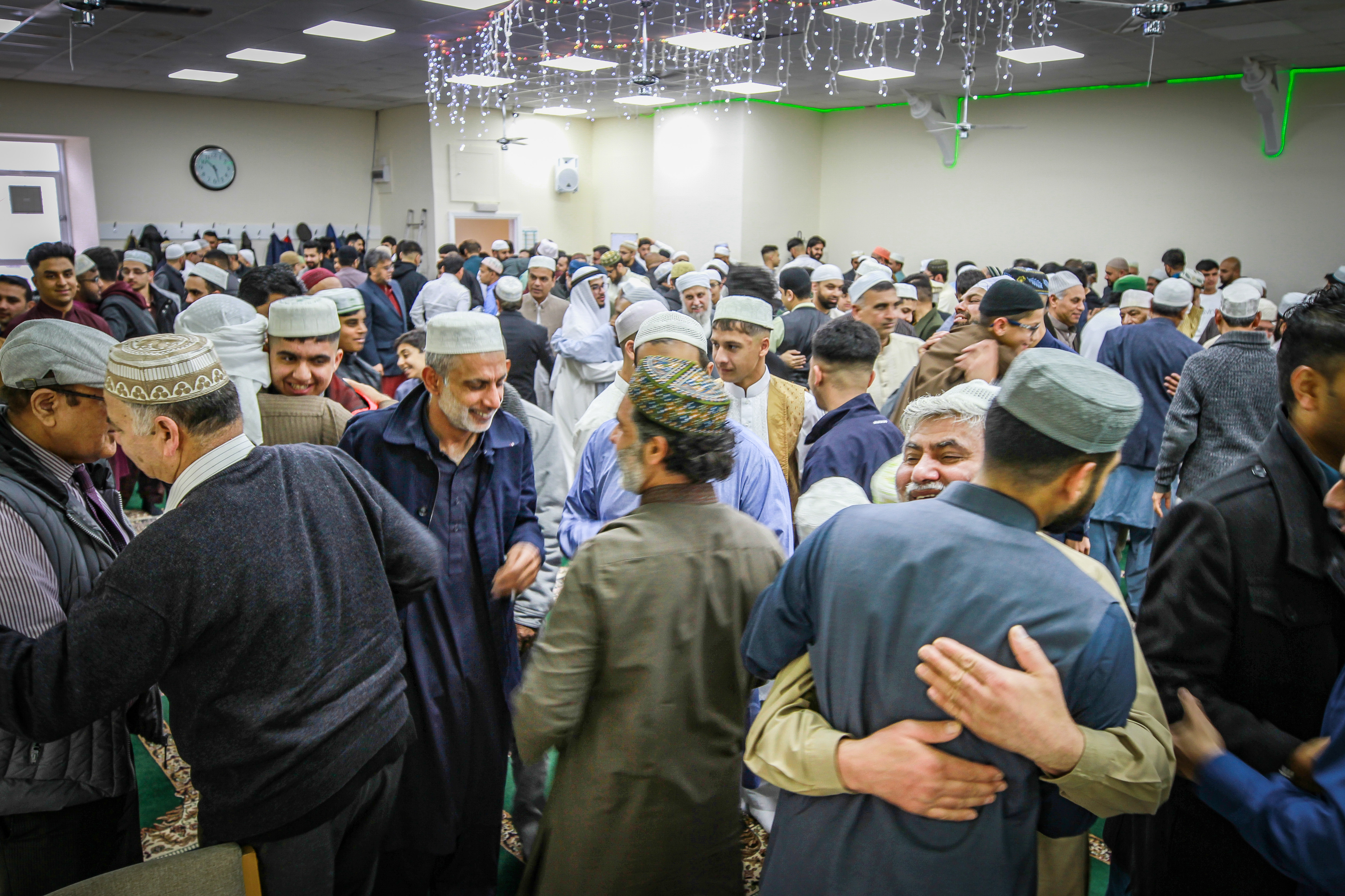 People embrace after prayers and celebrations at Dundee Islamic Society mosque to celebrate Eid.