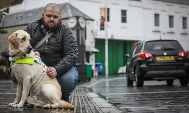 Jonathan Attenborough with guide dog Sam on Mill Street, where there are no kerbs to differentiate between road and pavement.