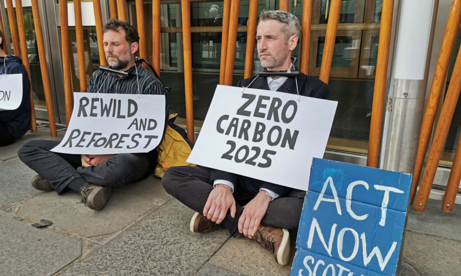 Activists from the Extinction Rebellion Scotland group with locks around their necks chained themselves to the Holyrood building with the means of freeing them sent to the leaders of the SNP, Conservatives, Labour, the Scottish Greens and the Liberal Democrats.