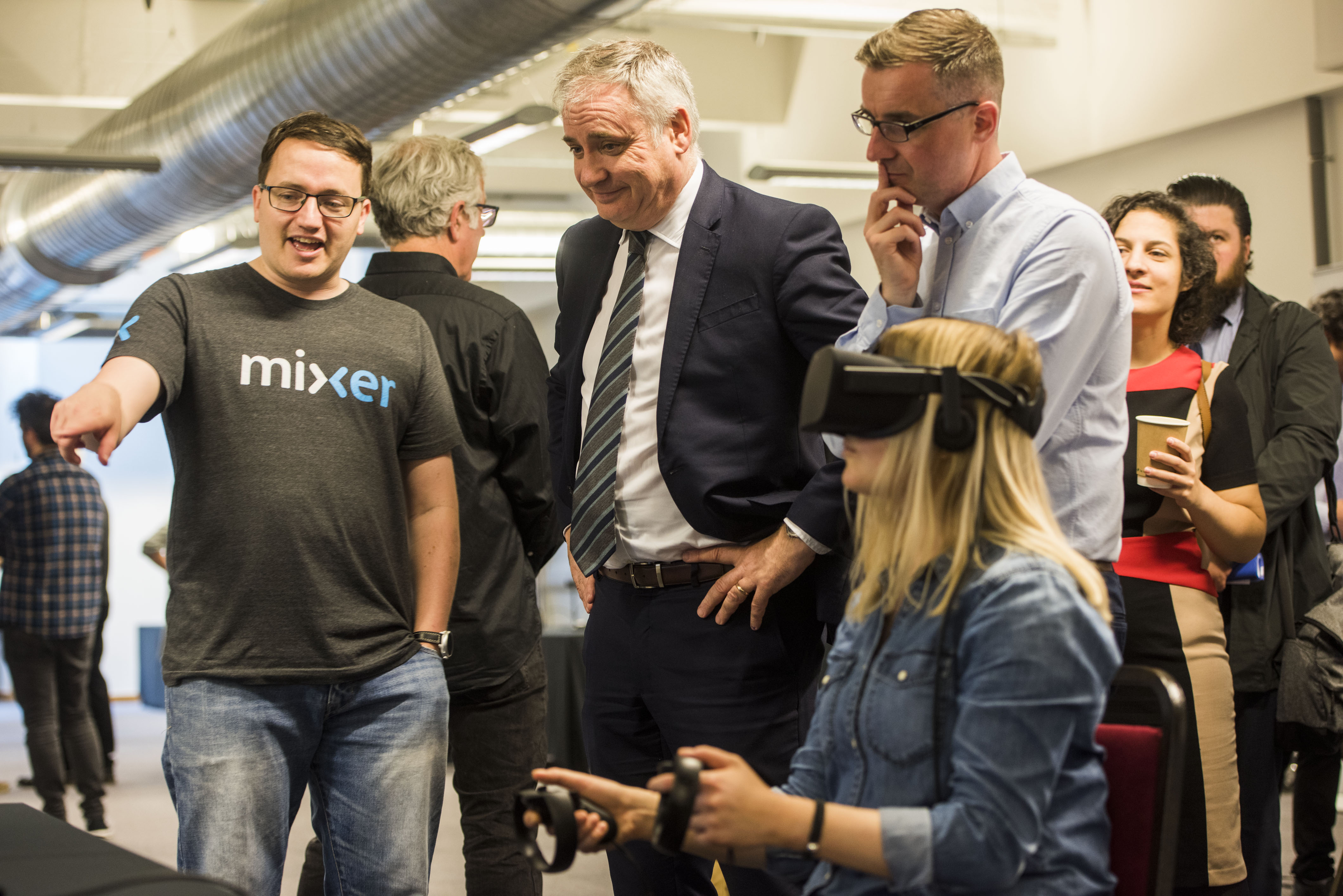 Gary McCartan (left), CEO of Pocket Sized Hands demonstrates a games project to Richard Lochhead MSP and Director of InGAME Sean Taylor