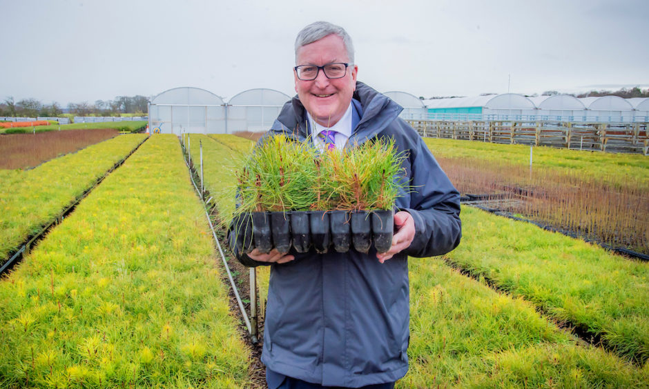 Fergus Ewing MSP, the Rural Economy Secretary, at a tree nursery in Scotland. Official figures show that Scotland has surpassed its targets for planting more trees across the country.