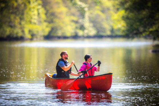 Gayle Ritchie and Ross Dempster in a canoe on River Lyon.