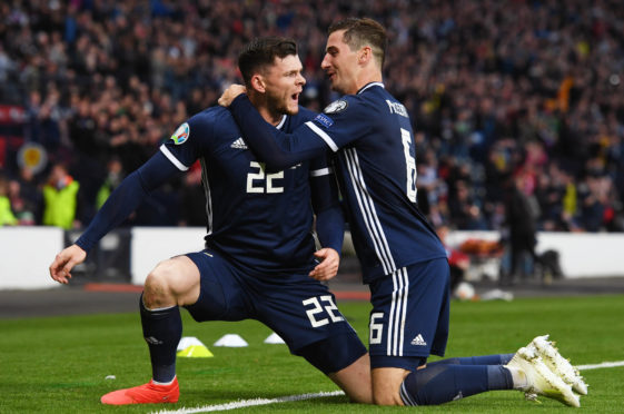 Kenny McLean (right) helps Oli Burke celebrate his winner against Cyprus.