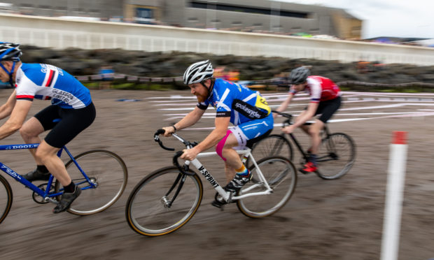 Cyclists compete by racing the track in the wet sand.
Steve Brown / DCT Media