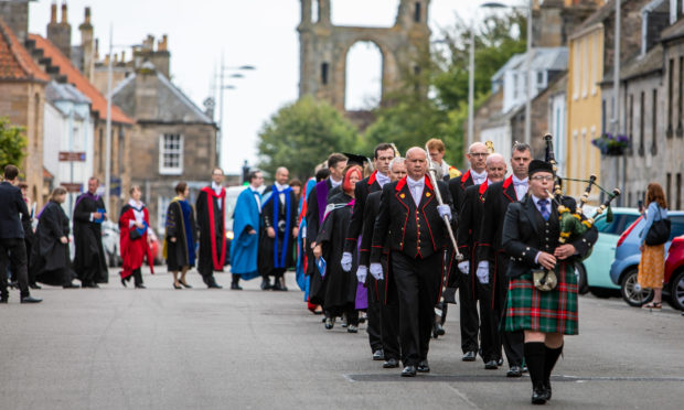 University procession heads towards St Salvators Quad after 2019 graduation ceremony.