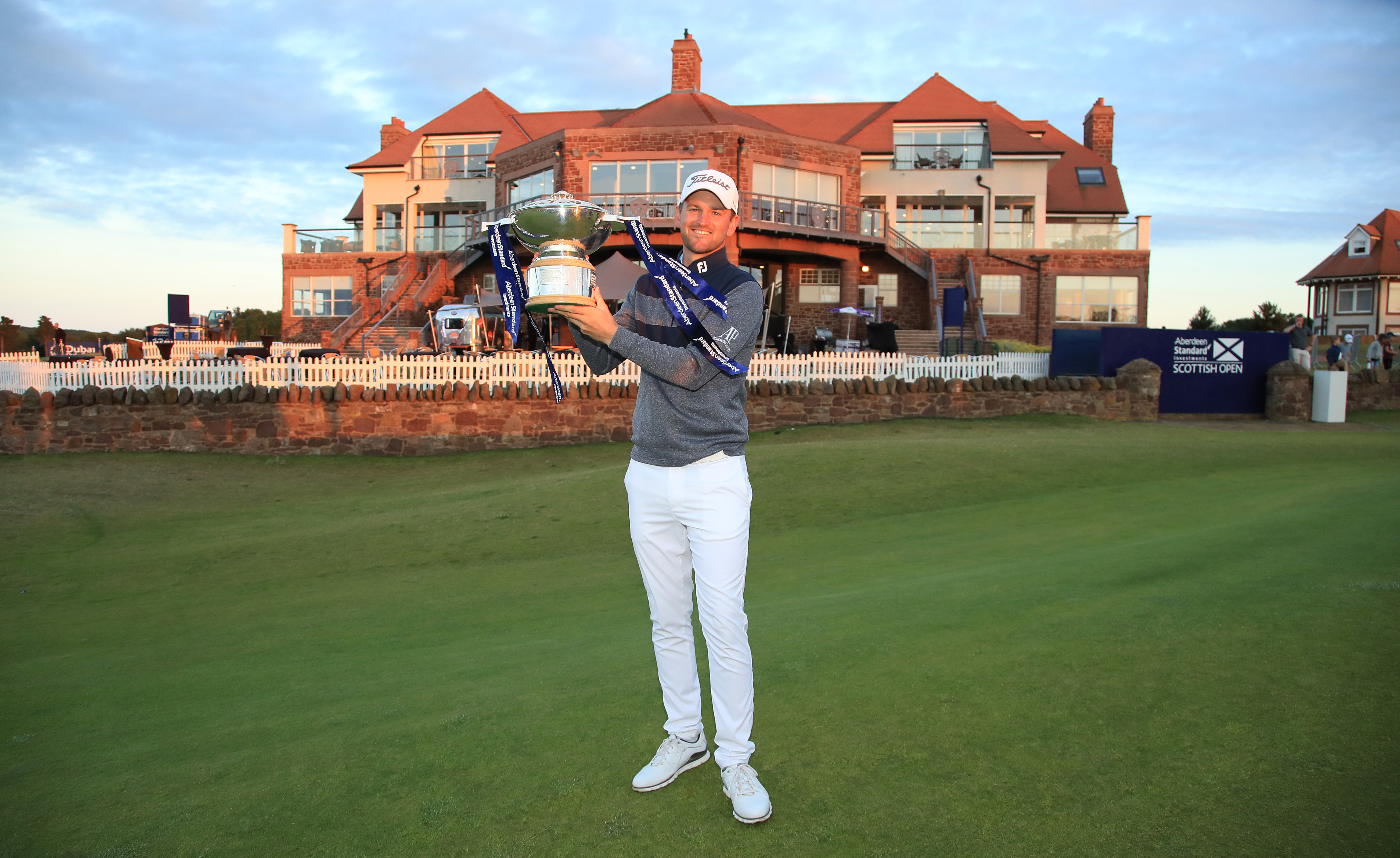 Bernd Wiesberger of Austria holds the Scottish Open trophy in front of the Renaissance clubhouse.