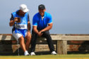 Brooks Koepka and caddie Ricky Elliott share a joke during practice for the Open Championship at Royal Portrush.