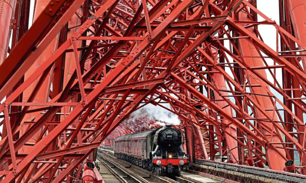 A steam train crossing the Forth Bridge