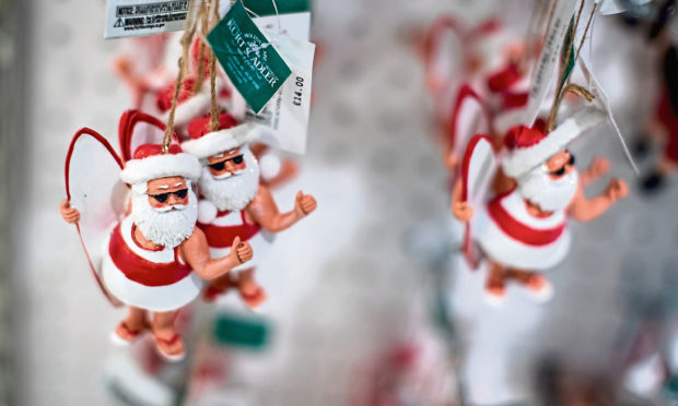 A Father Christmas in sunglasses decoration is displayed during a photocall as Future Fantasy Santa opens the Christmas shop at Selfridges in London.