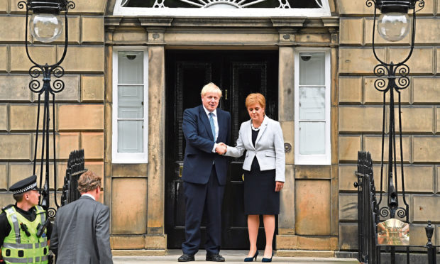 Scotland's First Minister Nicola Sturgeon welcomes Prime Minister Boris Johnson outside Bute House on July 29, 2019.