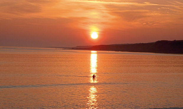 Anna Palmer is captured during a stunning sunrise swim in St Andrews.