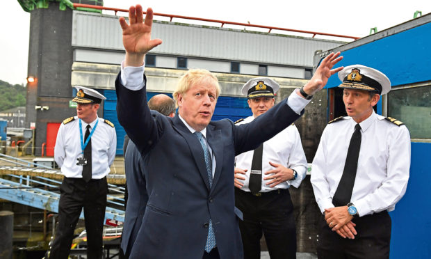 Britain's Prime Minister Boris Johnson gestures as visits HMS Victorious at HM Naval Base Clyde on July 29, 2019 in Faslane, Scotland.
