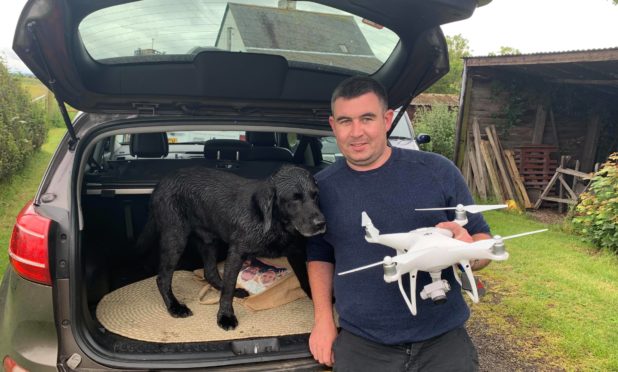 Dale Summerton with Buster and the drone he used to help find the missing dog.
