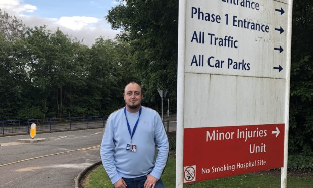 Councillor Ellis at the entrance to Queen Margaret Hospital