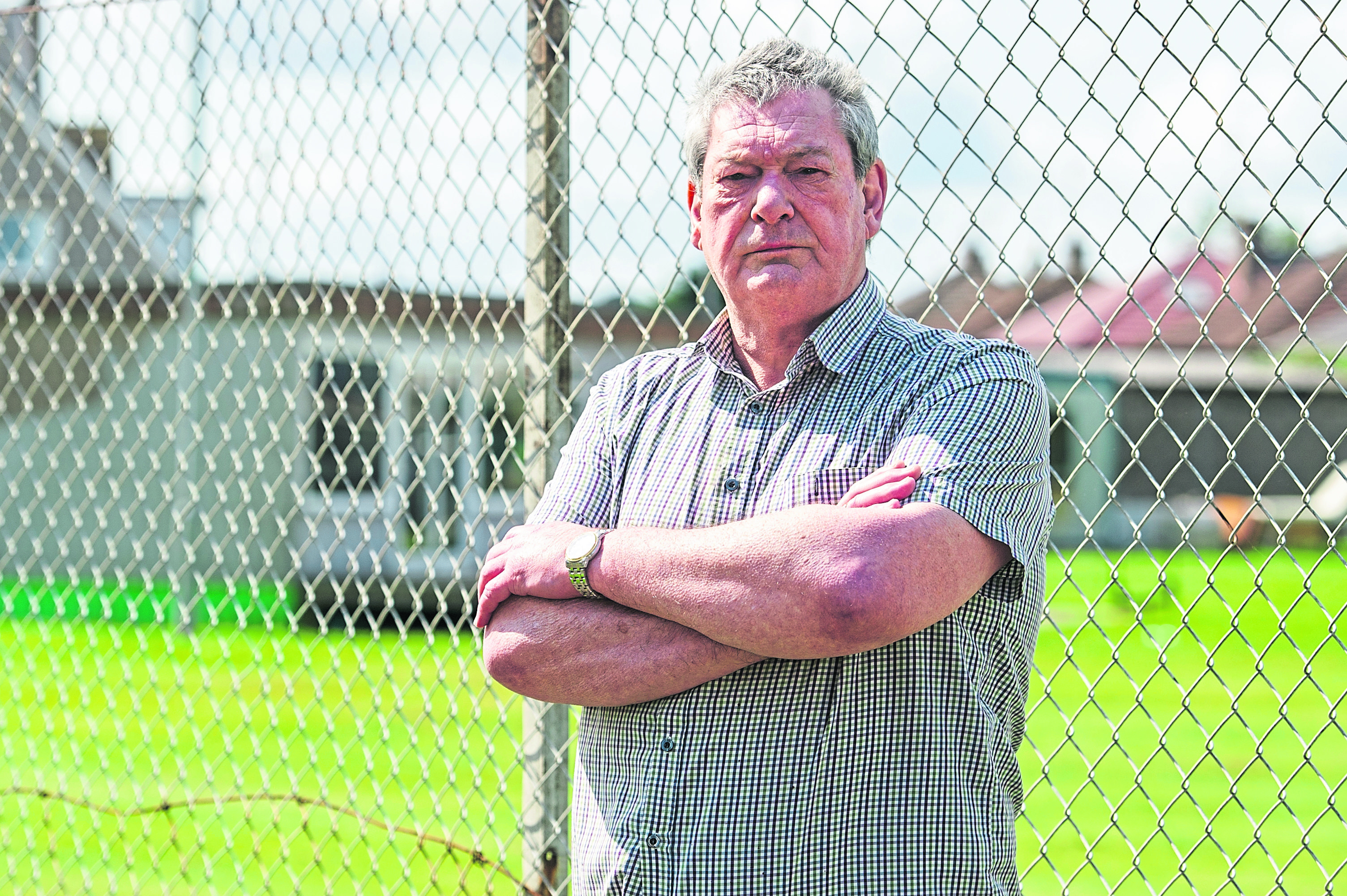 John McDonald outside the Montrose and District Cricket and Rugby Club ground with the clubhouse in the background that the cricket club built.