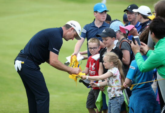 Justin Rose meets the locals at Portrush.
