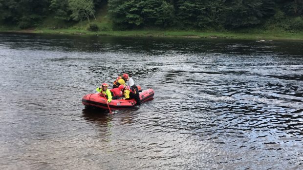 A water rescue team for the Scottish Fire and Rescue Service paddles on the River Tay near Stanley.